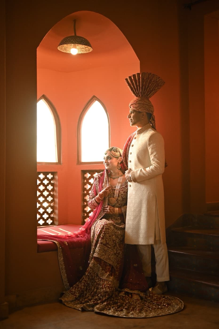 Wedding couple in a warm arched interior